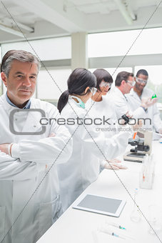 Chemist standing in front of tablet pc