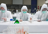 Chemists working in protective suits