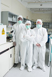 Team of chemists in protective suits