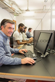 Cheerful man using the computer