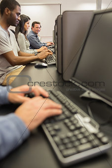 Mature student looking up from computer class