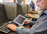 Man in computer class looking at tablet pc