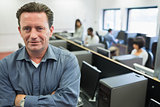 Man smiling at front of computer class