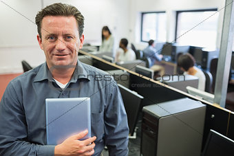 Man holding a tablet pc in computer room