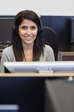 Smiling woman working in computer room