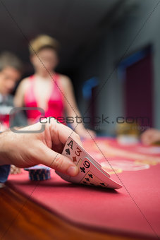 Man lifting poker hand