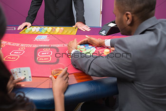 Man grabbing chips at poker table