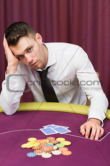 Man looking unhappy at poker table