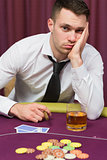 Man looking depressed at poker table