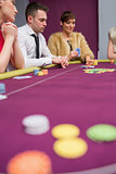 Woman placing bet at poker game
