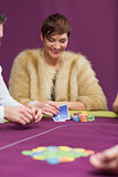 Woman smiling looking at her cards