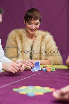 Woman smiling looking at her cards