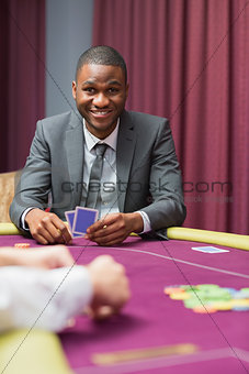 Smiling man looking up from poker