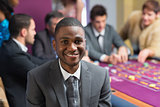 Smiling man sitting at roulette table