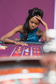 Woman looking upset at roulette table