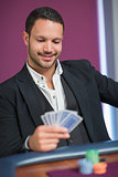 Man holding cards smiling