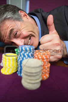 Man leaning on table and giving thumbs up