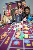 Women celebrating man's success at roulette
