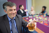 Man with whiskey glass at roulette table