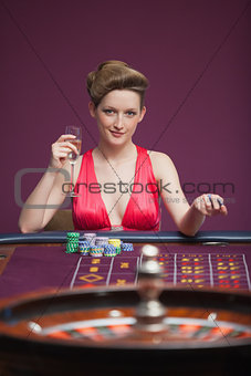 Woman sitting and playing roulette