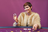Woman with champagne at poker table