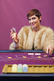 Woman drinking at table of a casino