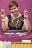 Woman holding chips in her hand in a casino