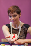 Woman at table holding dices