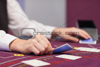 Dealer distributing cards in a casino