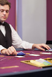 Dealer in a casino stacking cards