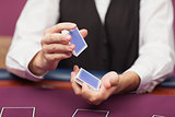 Dealer shuffling deck of cards in a casino