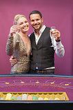 Two people toasting in a casino