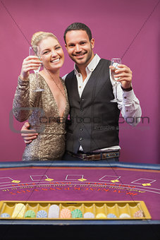 Two people toasting in a casino