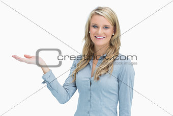 Cheerful woman presenting something