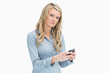 Blonde woman texting on her smartphone