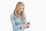 Woman looking surprised on her smartphone
