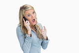 Woman looking shocked on the phone