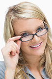 Smiling woman looking above her glasses