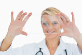 Smiling doctor holding up clear pane