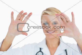 Doctor holding up clear pane and smiling