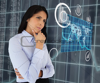 Woman standing thinking looking at world map hologram