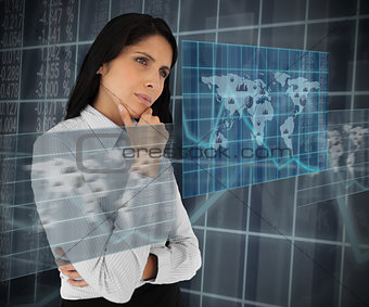 Businesswoman looking thoughtfully at world map