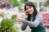 Florist touching a flower while calling