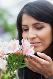 Woman smelling at the flower
