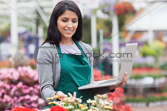 Woman checking stocks in garden center