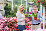 Couple holding flowers in garden center