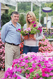 Cheerful couple choosing flowers