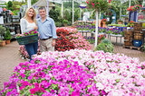 Smiling couple standing in the garden centre
