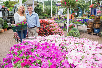 Smiling couple standing in the garden centre