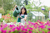 Cheerful gardener watering plants